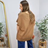 Camel brown short-sleeve oversized knit sweater top styled with wide-leg blue denim jeans, back view.