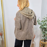 Collins Hooded Blazer in brown plaid worn over olive green hoodie with navy trousers, back view.