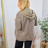 Collins Hooded Blazer in brown plaid worn over olive green hoodie with navy trousers, back view.