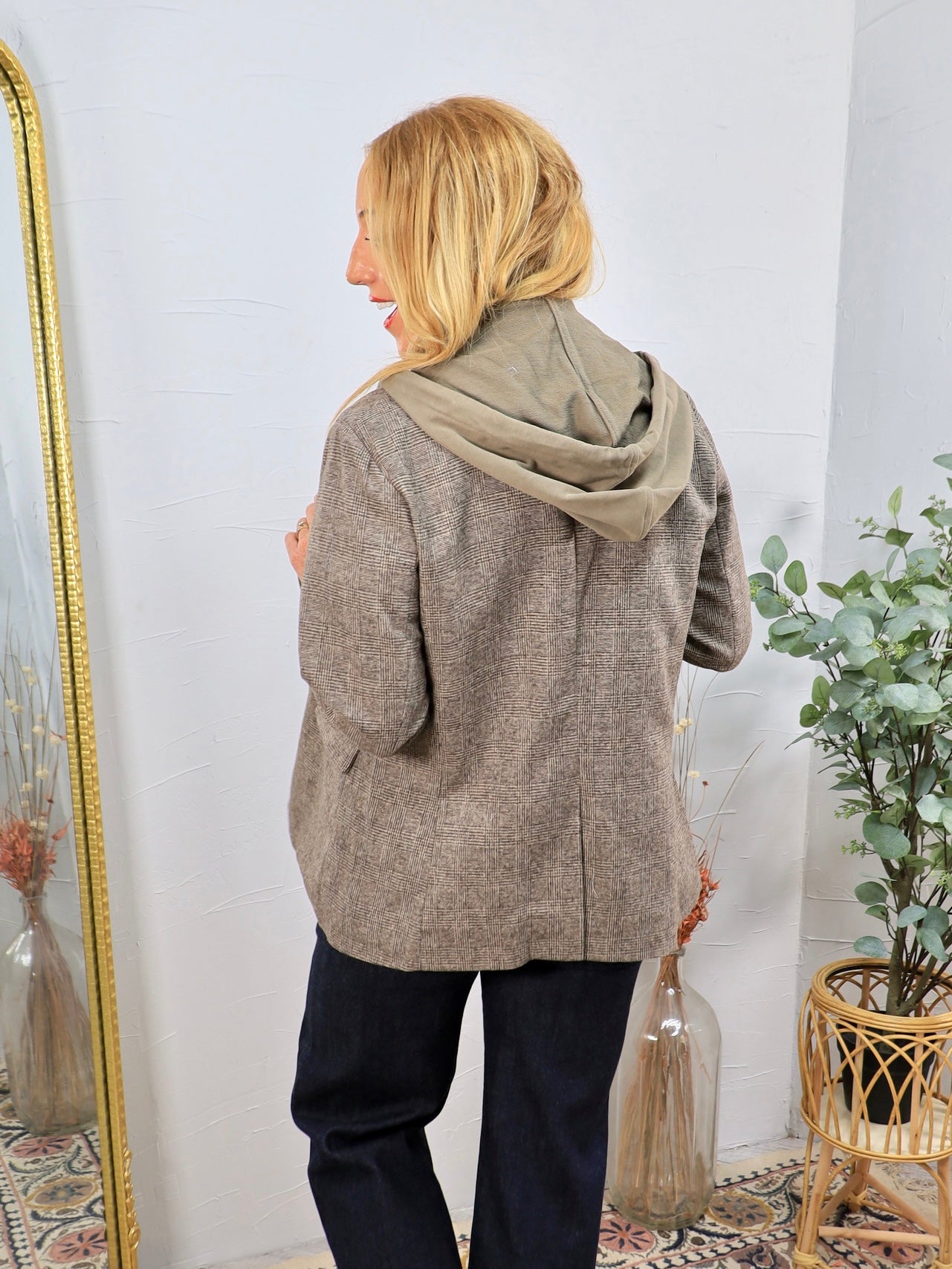 Collins Hooded Blazer in brown plaid worn over olive green hoodie with navy trousers, back view.