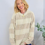 Oversized cream and tan striped fuzzy crewneck sweater styled with blue velvet pants and a pearl necklace.