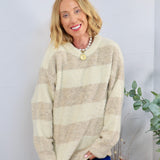 Oversized cream and tan striped fuzzy crewneck sweater styled with blue velvet pants and a pearl necklace.