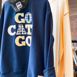 Navy blue game day sweatshirt with Go Cats Go gingham appliqué lettering on boutique hanger