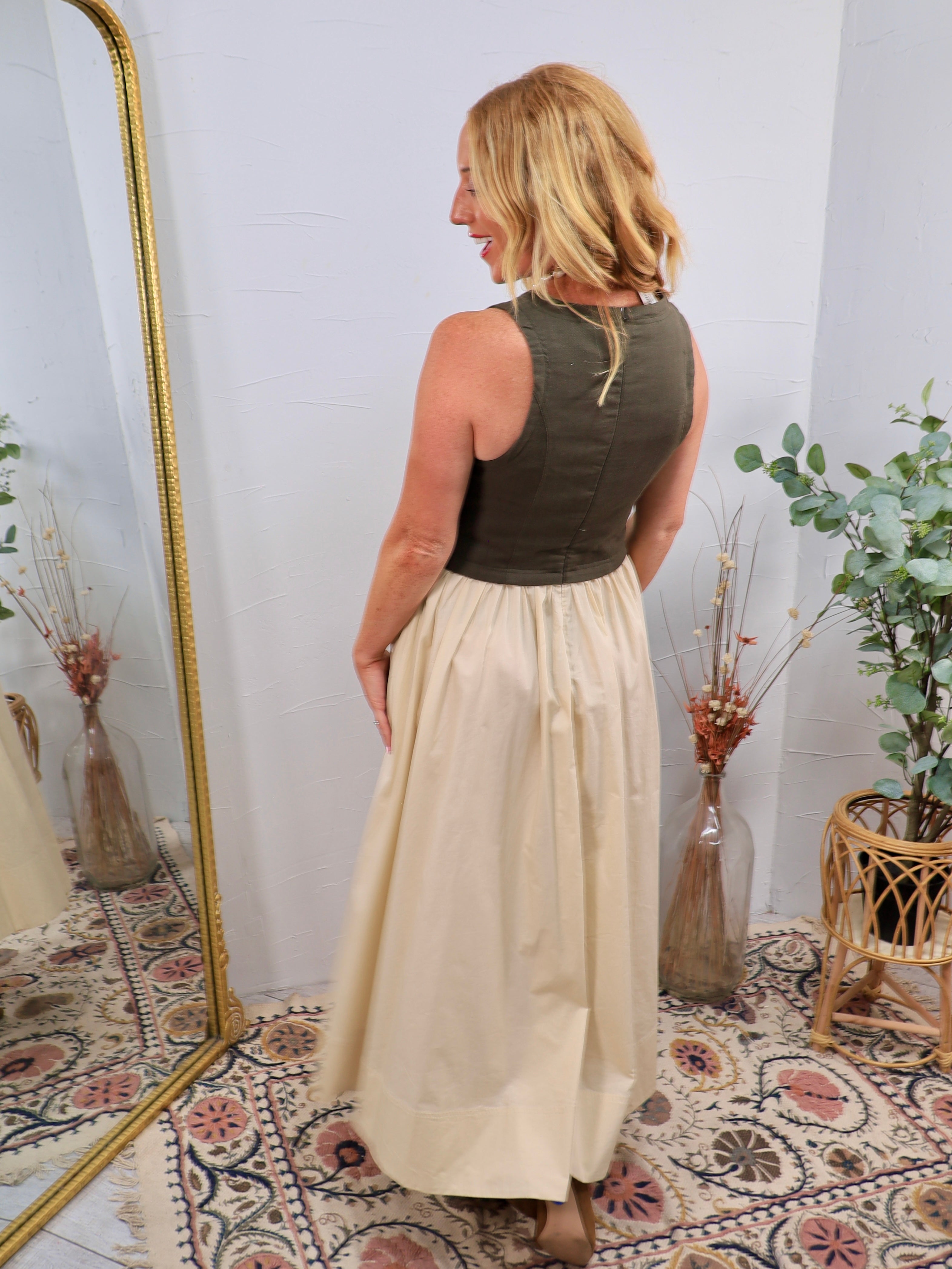 Olive sleeveless bodice contrast midi dress with cream flowing skirt, shown from back view.