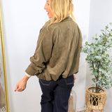 Olive green ruched suede jacket with rolled sleeves, styled with dark navy wide-leg jeans, back view.