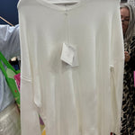 Cream white oversized sweater with drop shoulders and ribbed details on display