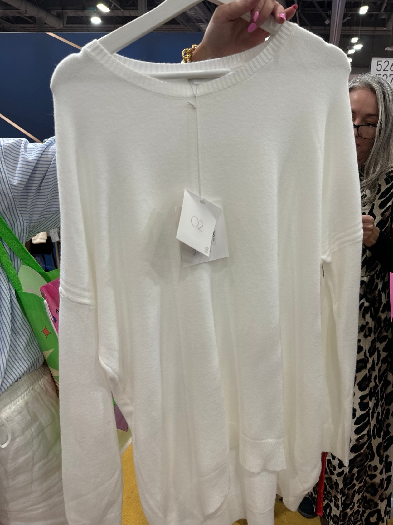 Cream white oversized sweater with drop shoulders and ribbed details on display