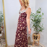 Burgundy floral maxi dress with white lace neckline trim, worn by blonde model with heeled sandals.