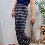 Wide-leg navy striped knit lounge pants with burgundy and cream horizontal stripes, styled with navy top