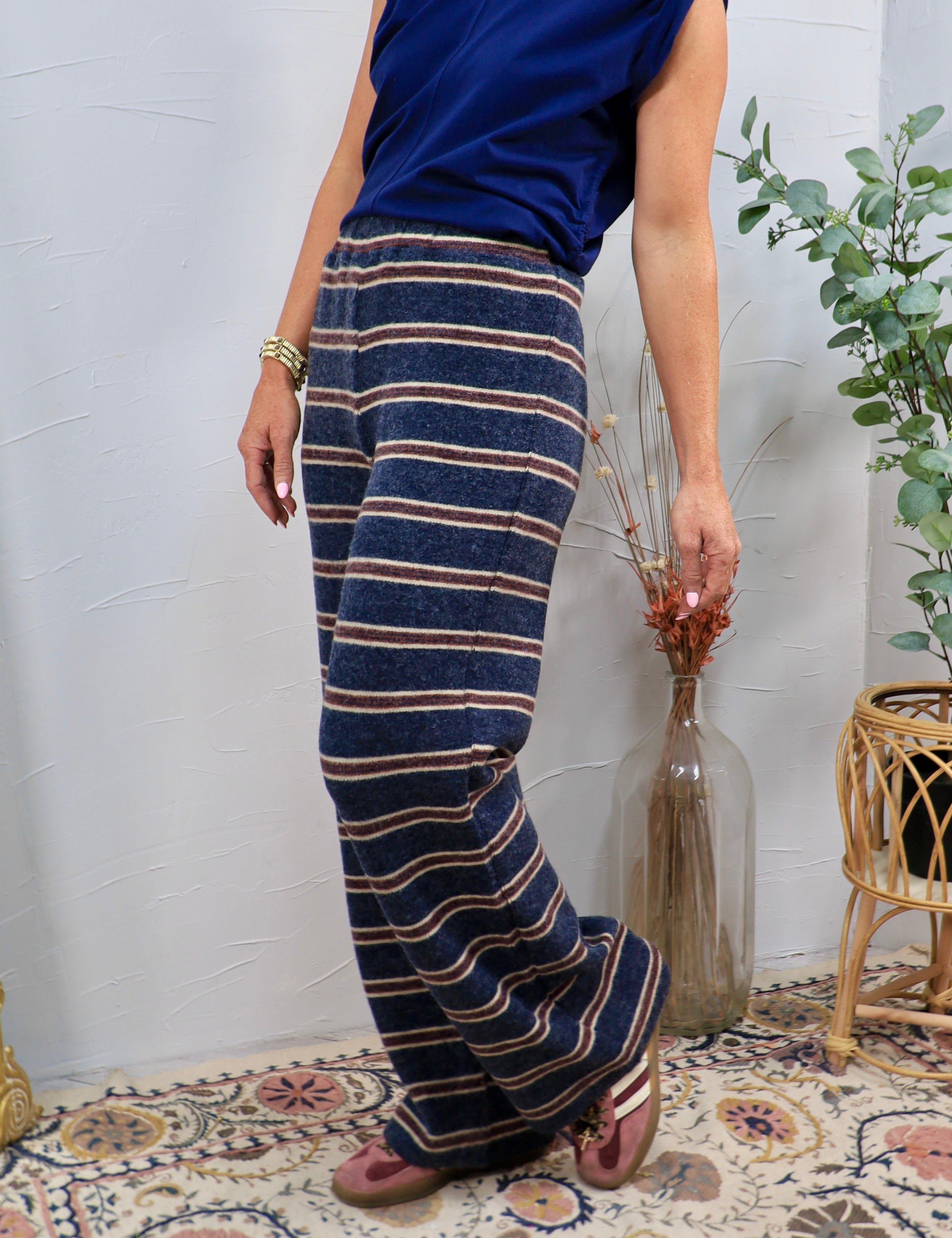 Wide-leg navy striped knit lounge pants with burgundy and cream horizontal stripes, styled with navy top