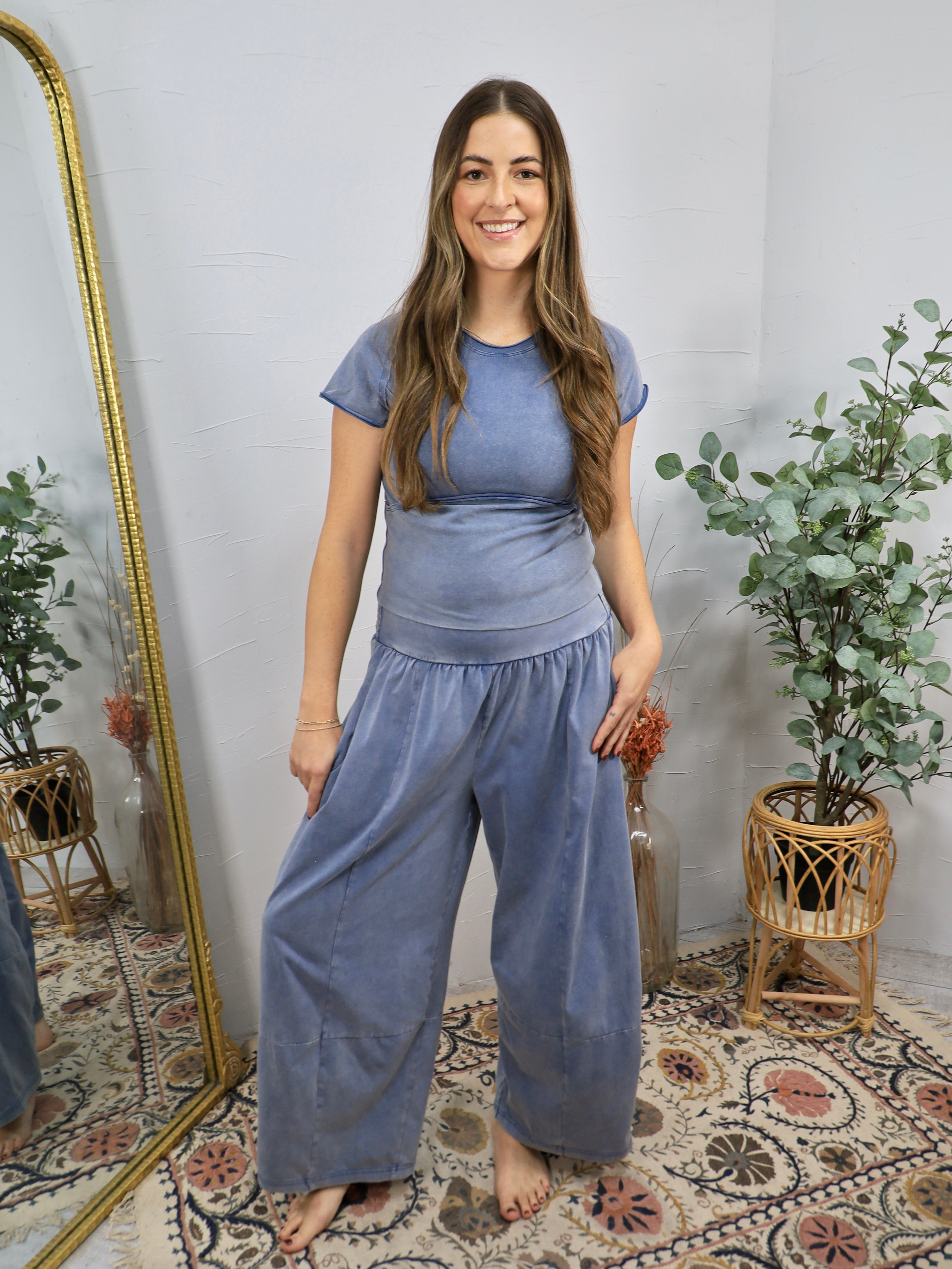 Mineral-washed blue short sleeve fitted crop top with ribbed waistband, styled with matching wide-leg pants.