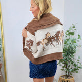 Brown and cream knit horse-print sweater with wide collar, styled with blue paisley mini skirt and red cowboy boots.