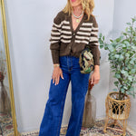 Brown and cream striped knit cardigan styled with wide-leg blue jeans, worn by blonde model with sunglasses.