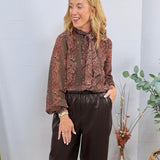 Brown and mauve floral print chiffon blouse with pussy bow neck tie, styled with dark chocolate faux leather wide-leg trouser