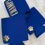 Royal blue neoprene koozies with gold embroidered paw print and "Champs" text lettering.