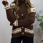 Brown and cream geometric patterned button-front cardigan layered over a brown turtleneck with black pants.