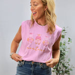 Pink sleeveless muscle tee with embroidered Montana text and cute graphics worn with jeans