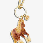 Solar Eclipse horse keychain in cream and brown resin with gold etched details and gold-tone clasp.