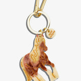 Solar Eclipse horse keychain in cream and brown resin with gold etched details and gold-tone clasp.