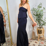 Woman wearing navy blue strapless halter top and matching wide-leg flowy pants, styled as elegant coordinated set in bohemian