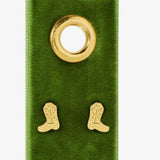 Pair of gold cowboy boot stud earrings displayed on a green velvet jewelry card with gold grommet