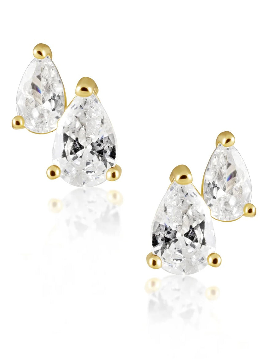 Gold stud earrings featuring two pear-shaped clear crystals in different sizes on each ear, displayed against white backgroun