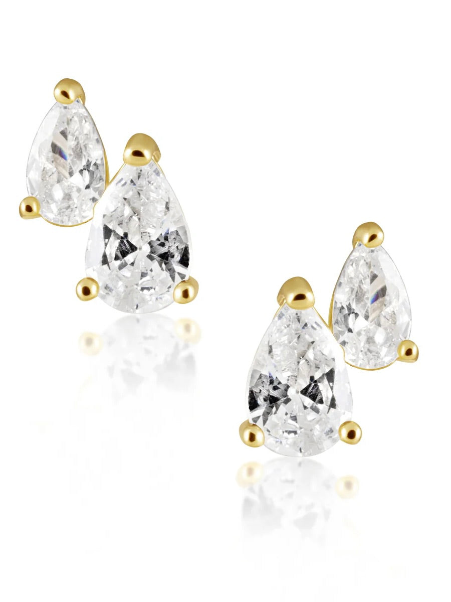 Gold stud earrings featuring two pear-shaped clear crystals in different sizes on each ear, displayed against white backgroun