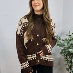 Brown and cream western-patterned knit cardigan with gold buttons, layered over brown turtleneck.
