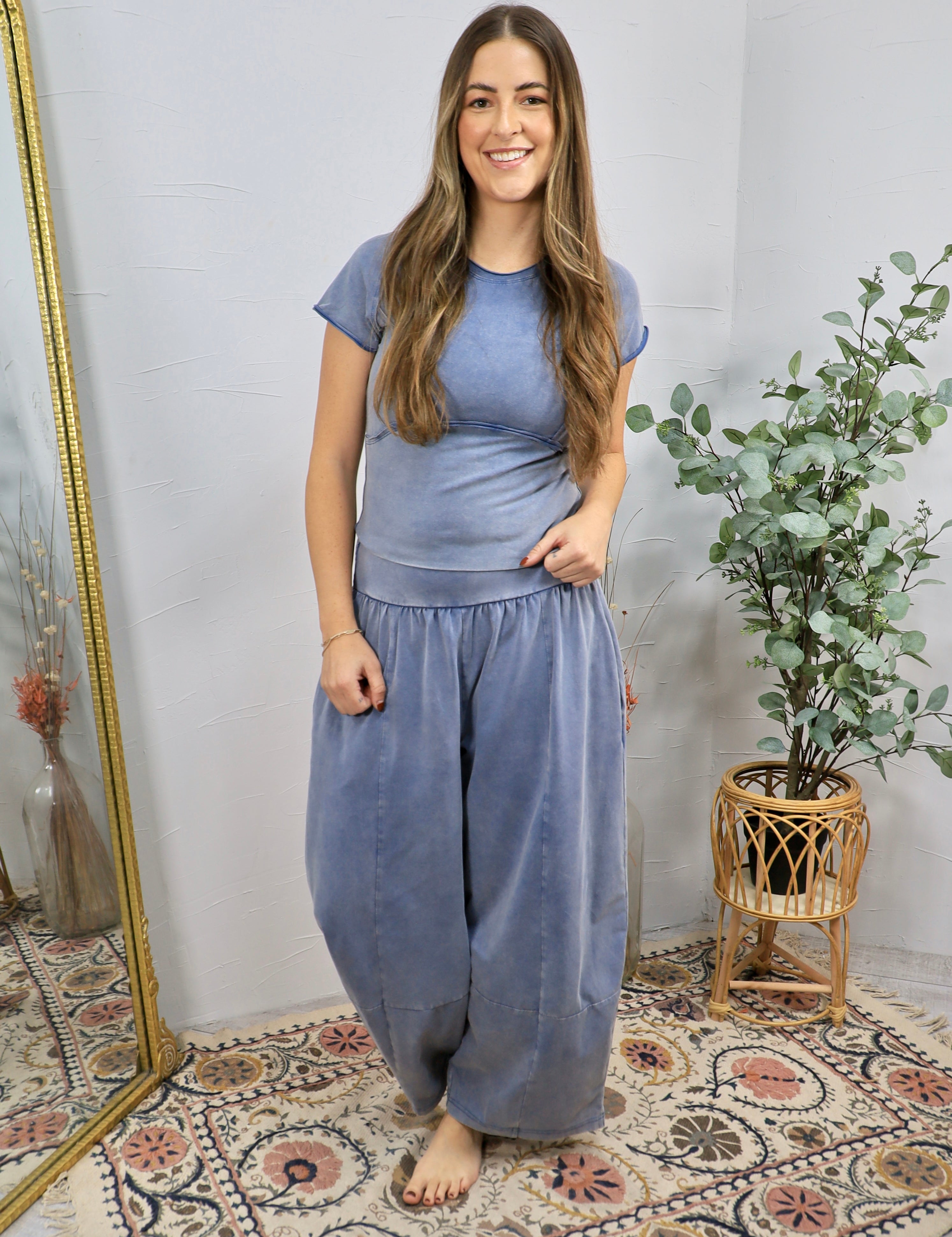 Mineral-washed blue short-sleeve fitted crop top with seam detail, styled with matching wide-leg pants.