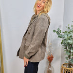 Collins Hooded Blazer in brown plaid, styled over olive hoodie with dark jeans, featuring gold buttons.