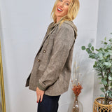 Collins Hooded Blazer in brown plaid, styled over olive hoodie with dark jeans, featuring gold buttons.