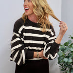 Woman wearing a dark brown and cream striped cropped crewneck sweater with balloon sleeves