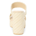 Cream woven raffia block heel sandal with double straps, shown from back view.