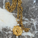 Gold chain necklace featuring a Roman coin pendant with pearl accents and toggle clasp closure.