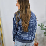 Navy blue paisley print crewneck sweatshirt styled with light wash jeans, shown from the back.