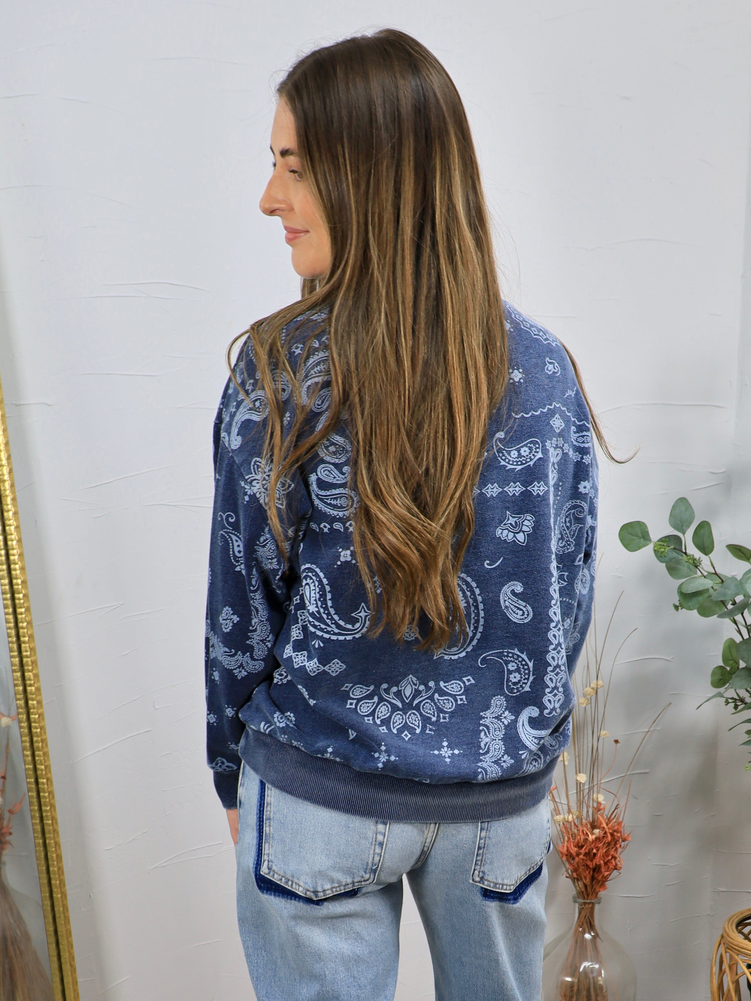 Navy blue paisley print crewneck sweatshirt styled with light wash jeans, shown from the back.
