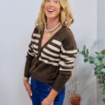 Brown and cream striped knit cardigan styled with blue jeans, pearl necklace, and gold coin pendant.