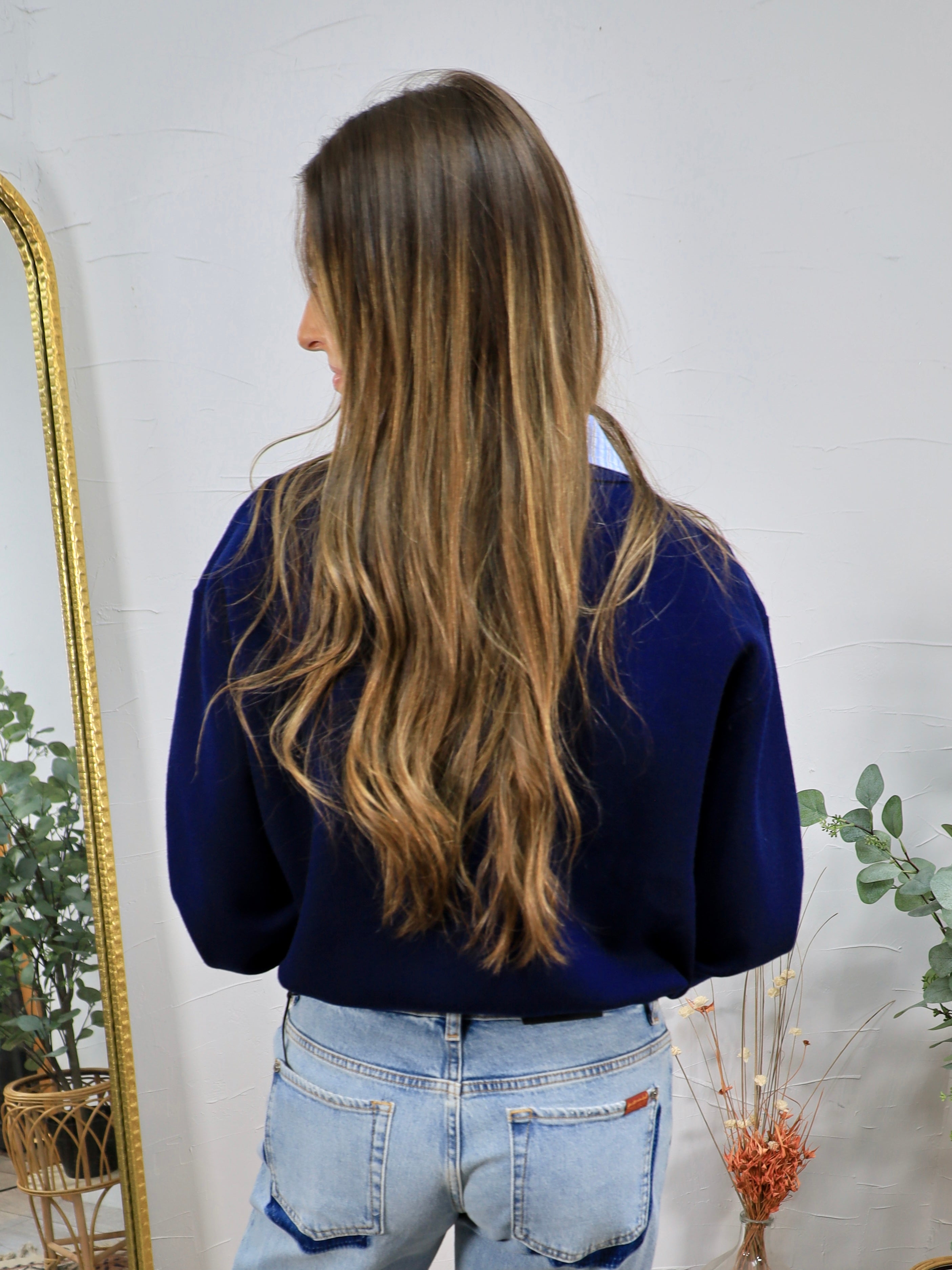 Navy blue contrast collar cardigan styled with light wash jeans, shown from the back view.