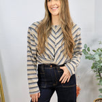 Beige striped long-sleeve Sami Top with chevron pattern, styled with dark navy wide-leg jeans.