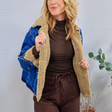Blue denim jacket with tan sherpa teddy lining, worn open over brown turtleneck and matching brown pants.