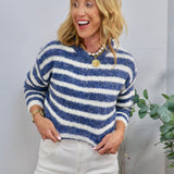 Blue and white horizontal striped knit crewneck sweater styled with white jeans and gold coin necklace.