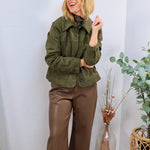 Woman wearing olive green cropped suede jacket with brown wide-leg faux leather pants