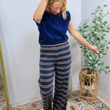 Navy blue striped wide-leg lounge pants styled with a matching cobalt blue short-sleeve top.