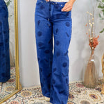 Blue wide-leg denim jeans with navy shell print pattern and drawstring waist
