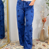 Blue wide-leg denim jeans with navy shell print pattern and drawstring waist