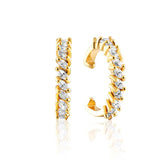 Gold tone ear cuffs with sparkling baguette crystals arranged in jagged pattern