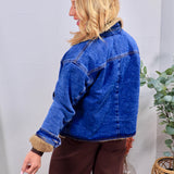 Blue denim Graham Teddy Jacket with tan sherpa lining, collar, and cuffs, styled with brown wide-leg pants.