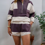 Purple and cream striped lounge shorts with elastic waistband and contrast topstitching, worn as a matching set