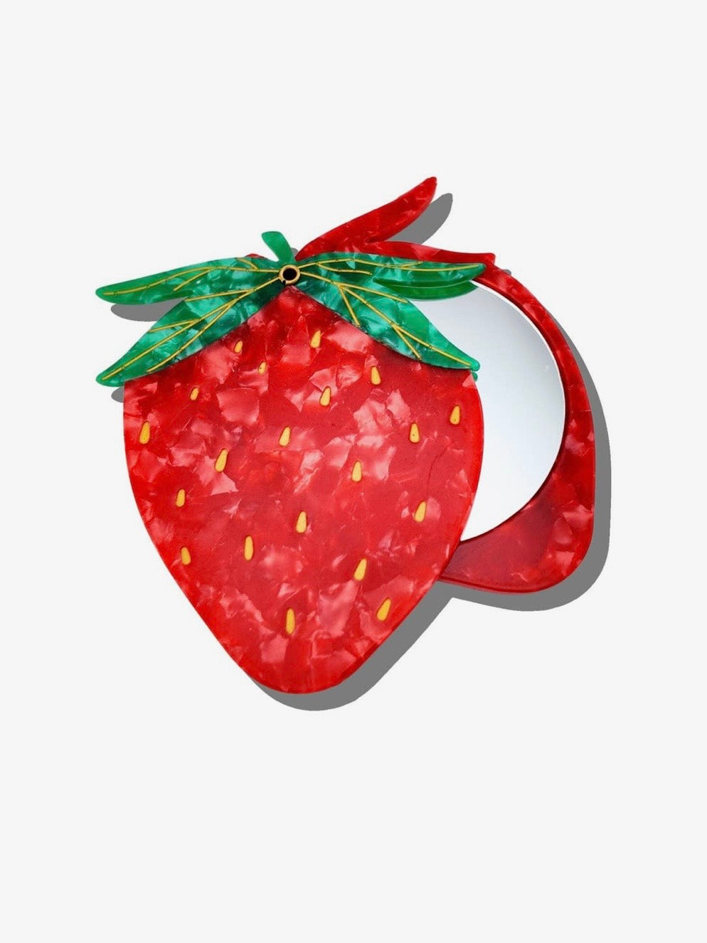 Strawberry-shaped compact mirror in red marbled acrylic with green leaf hinge, yellow seed details, open revealing round mirr