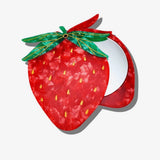 Strawberry-shaped compact mirror in red marbled acrylic with green leaf hinge, yellow seed details, open revealing round mirr